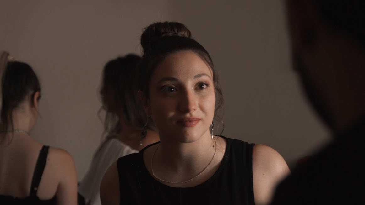 Mujer en un ambiente social observando con gesto atento